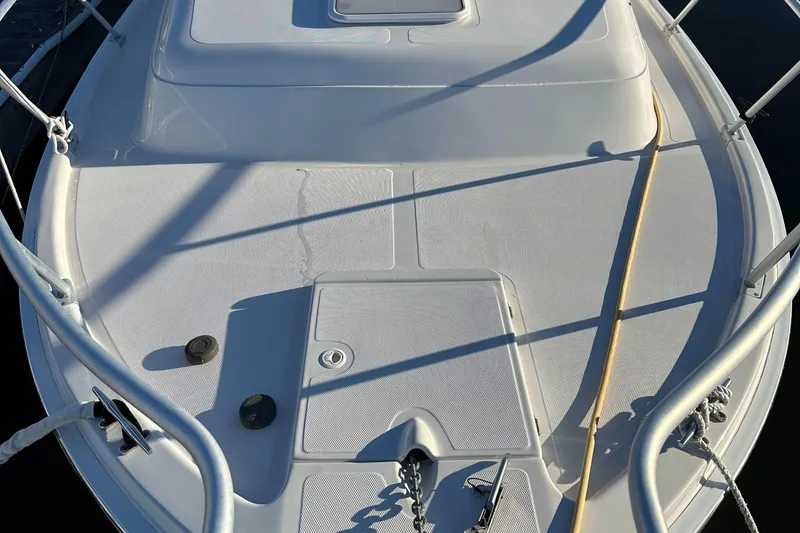 Slide: The Image of 2001 Mainship Pilot 30 boat deck with railing and hatch, in sunlight. - 9