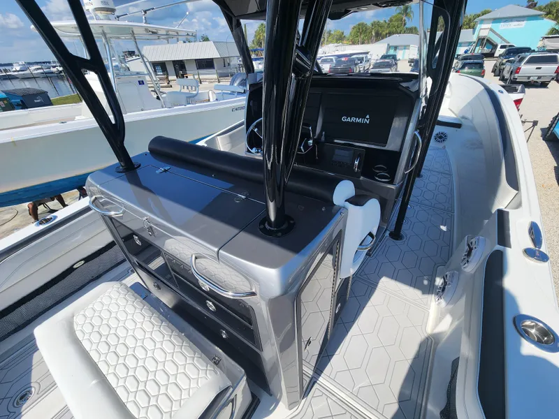 Slide: The Image of 2023 Nor-Tech 340 Sport Center Console boat with Garmin navigation system, sleek interior design. - 10