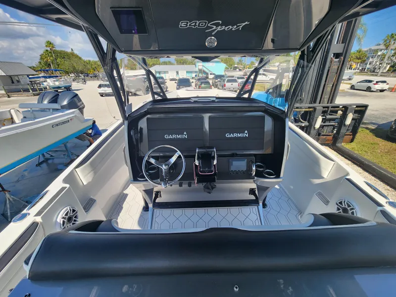 Slide: The Image of 2023 Nor-Tech 340 Sport Center Console boat interior with dual Garmin displays. - 11