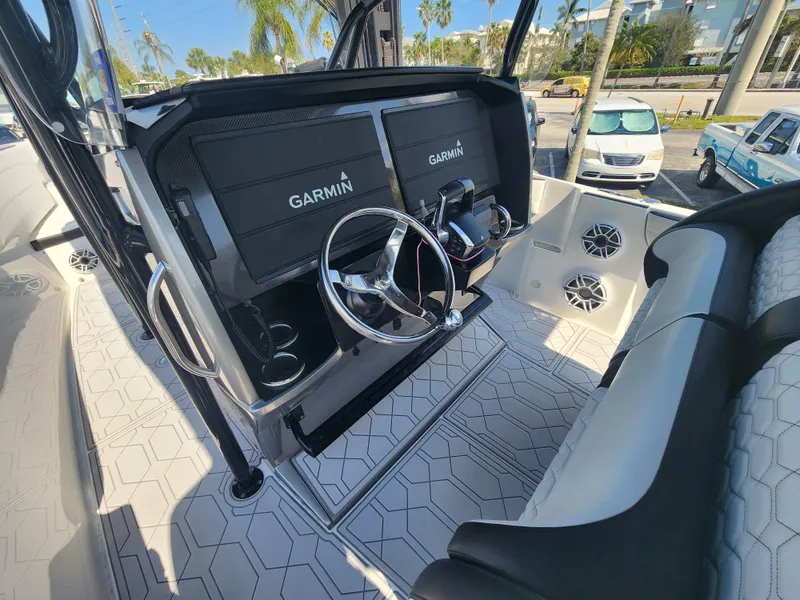 Slide: The Image of 2023 Nor-Tech 340 Sport Center Console with Garmin displays and modern steering wheel. - 12