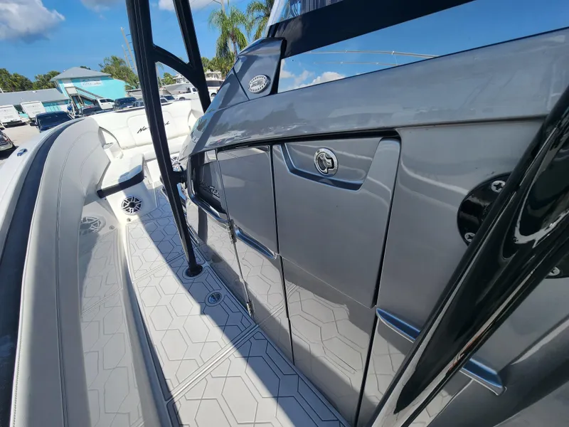Slide: The Image of 2023 Nor-Tech 340 Sport Center Console, sleek design, side view, sunny day, modern features. - 13
