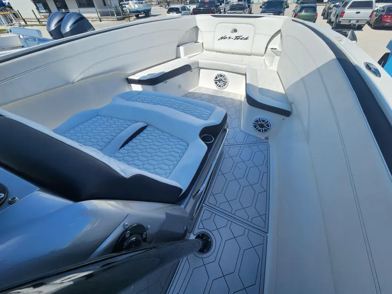 Slide: The Image of 2023 Nor-Tech 340 Sport Center Console boat interior with luxurious seating and modern design. - 16