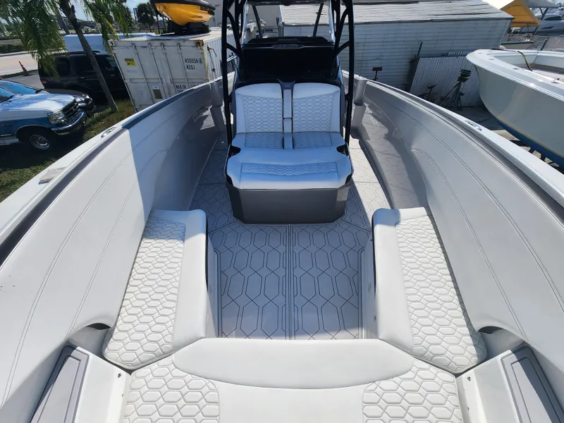 Slide: The Image of 2023 Nor-Tech 340 Sport Center Console boat with white seating and hexagonal pattern flooring. - 22