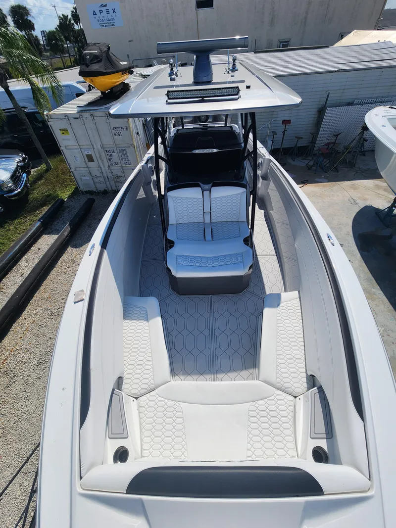Slide: The Image of 2023 Nor-Tech 340 Sport Center Console boat with spacious seating and modern design. - 23