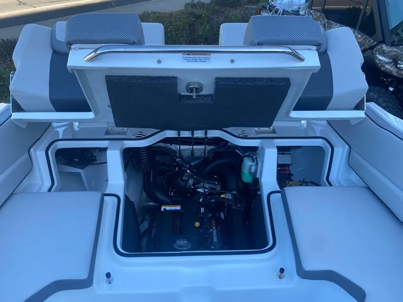 Slide: The Image of 2025 Scarab 195 SE boat engine compartment with open hatch, showcasing interior components. - 13