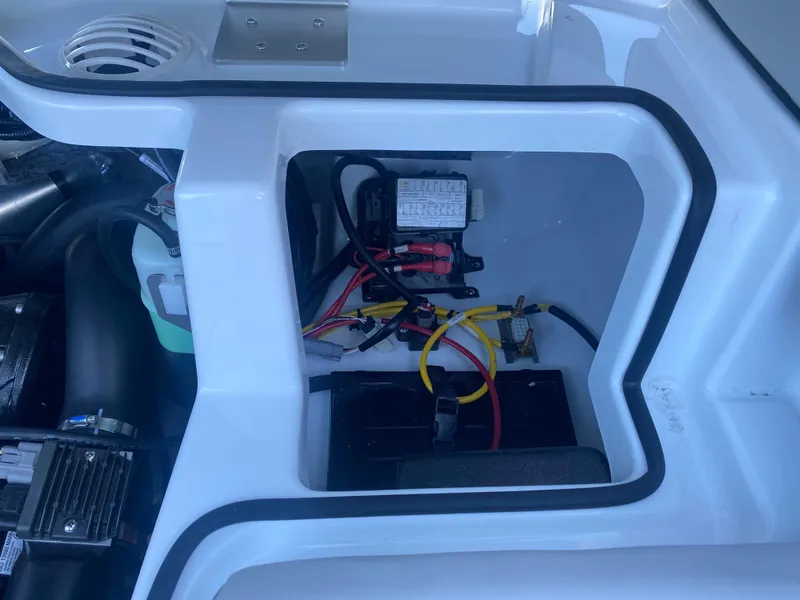 Slide: The Image of Engine compartment of 2025 Scarab 195 SE boat with visible wiring and components. - 15
