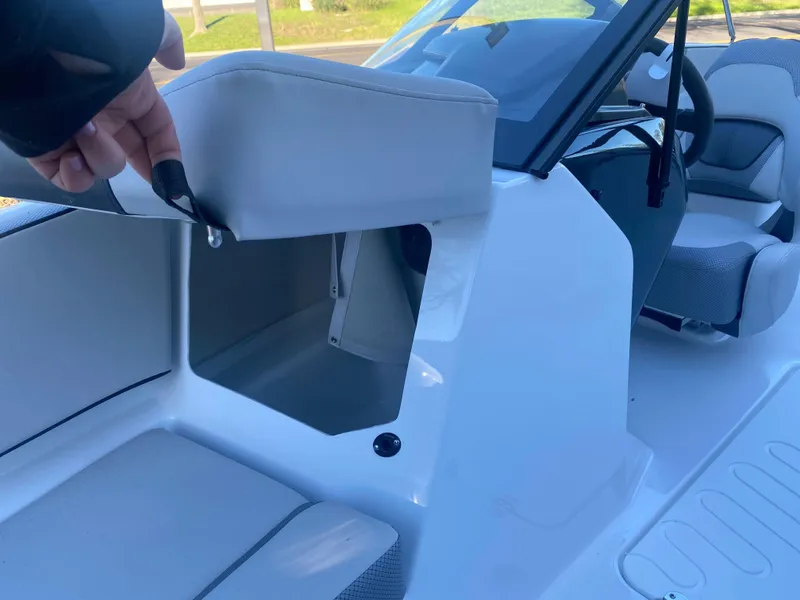 Slide: The Image of 2025 Scarab 195 SE boat interior with open storage compartment. - 16