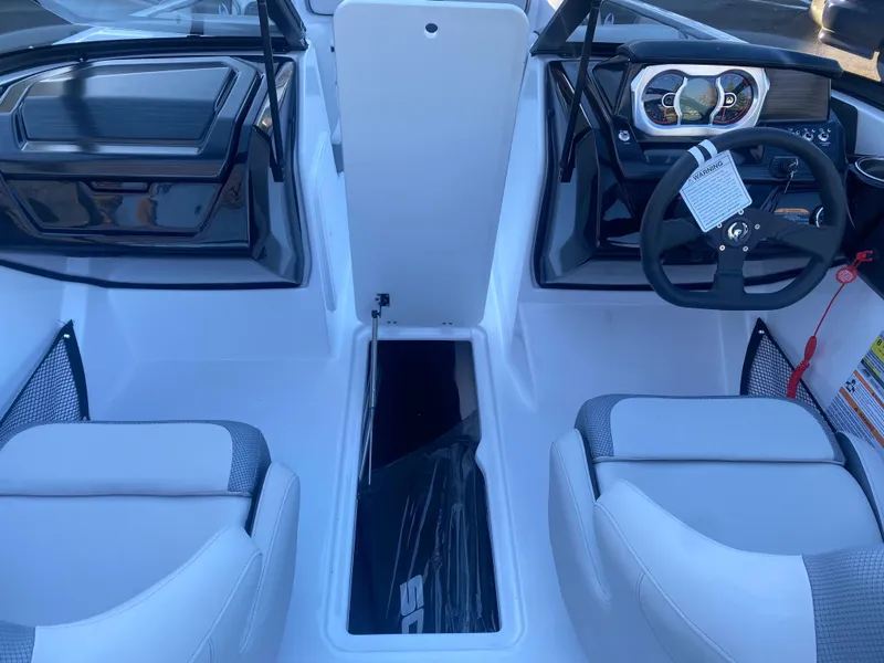 Slide: The Image of Interior of 2025 Scarab 195 SE boat, featuring modern dashboard and seating. - 18