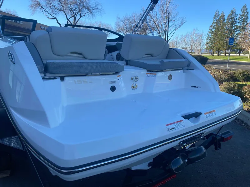 Slide: The Image of 2025 Scarab 195 SE boat, rear view with seating and sleek design. - 21