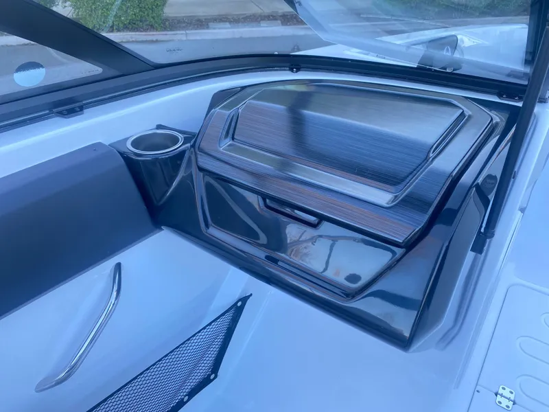 Slide: The Image of 2025 Scarab 215 SE boat interior with sleek dashboard and cup holder. - 14