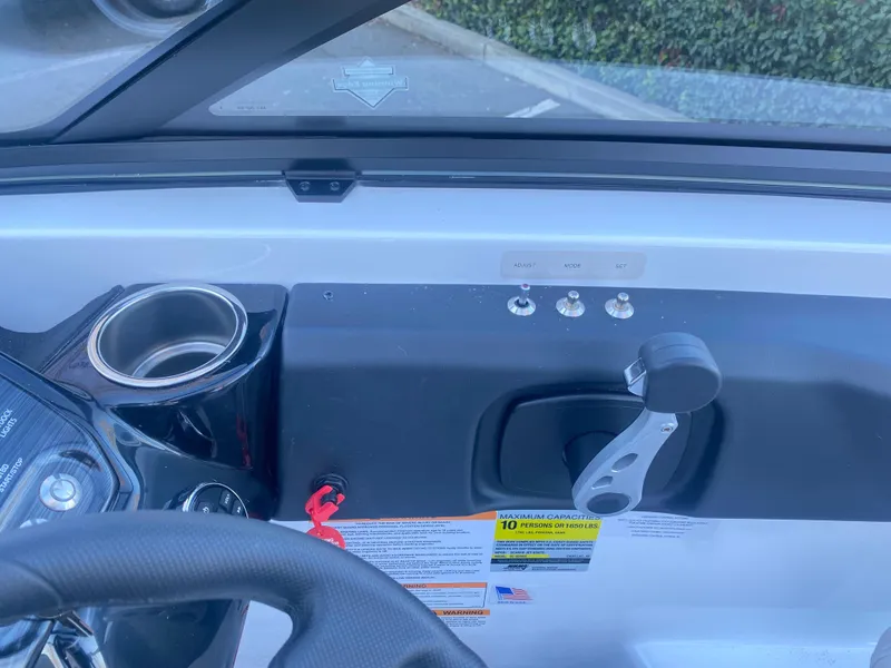 Slide: The Image of Dashboard of 2025 Scarab 215 SE boat with controls and cup holder. - 17