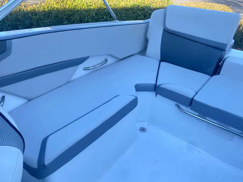 Slide: The Image of 2025 Scarab 215 SE boat interior with white and gray seating. - 18