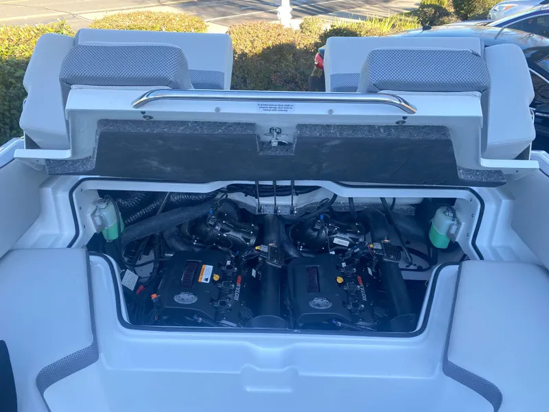 Slide: The Image of 2025 Scarab 215 SE boat engine compartment with dual engines, open hatch view. - 21