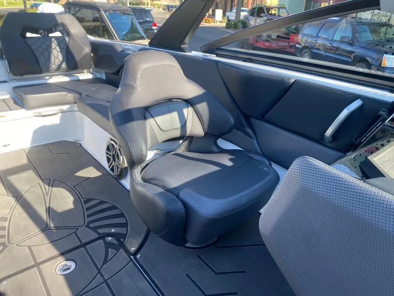 Slide: The Image of 2025 Scarab 235 LX Wake boat interior with black seating and modern design. - 11