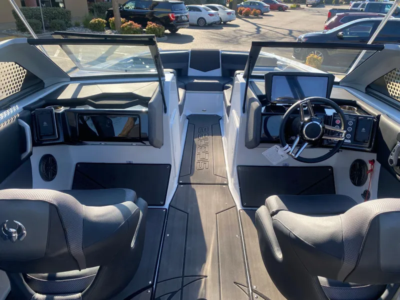 Slide: The Image of 2025 Scarab 235 LX Wake boat interior with modern dashboard and seating. - 15
