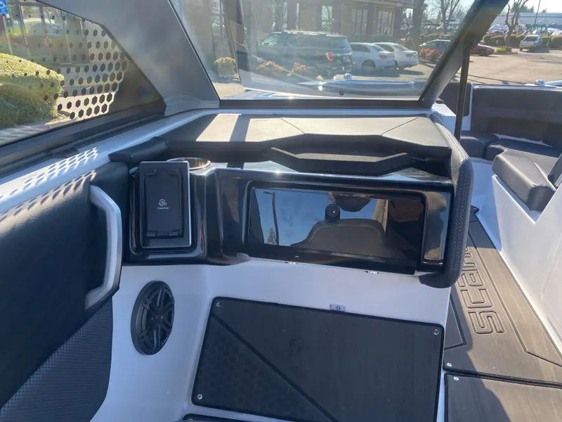 Slide: The Image of Interior view of 2025 Scarab 235 LX Wake boat, featuring sleek dashboard and seating. - 16