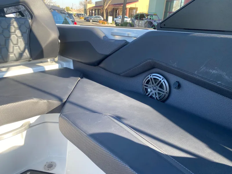 Slide: The Image of Interior of 2025 Scarab 235 LX Wake boat with black seating and speaker detail. - 19