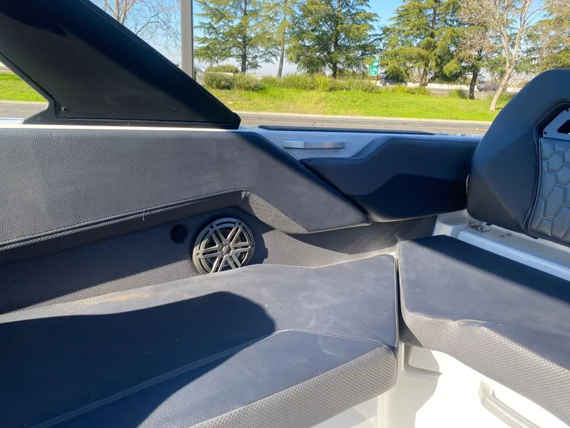 Slide: The Image of Interior of 2025 Scarab 235 LX Wake boat with sleek seating and speaker. - 20