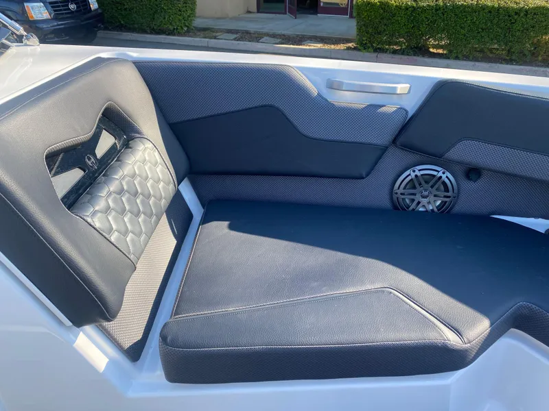 Slide: The Image of 2025 Scarab 235 LX Wake boat interior seating with stylish upholstery and speaker. - 8