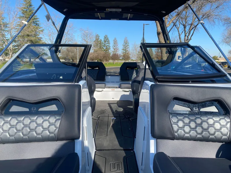 Slide: The Image of 2025 Scarab 235 LX Wake boat interior with black seating and open cockpit. - 9