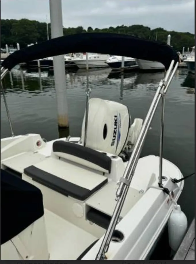 Slide: The Image of 2018 Stingray 206 CC boat with Suzuki engine docked at marina. - 4