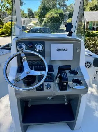 Slide: The Image of 2018 Stingray 206 CC boat console with steering wheel and Simrad display. - 5