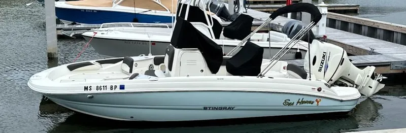 Slide: The Image of 2018 Stingray 206 CC boat docked in marina. - 6