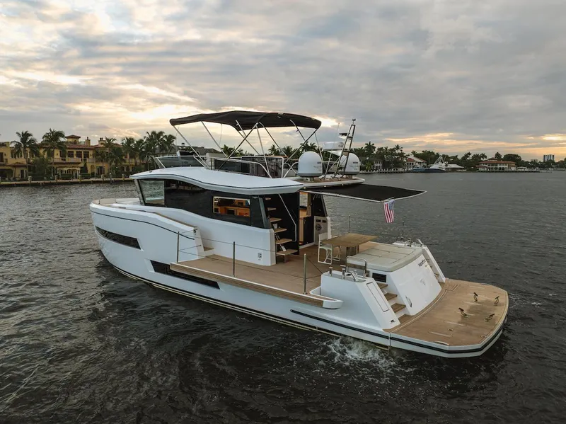 Slide: The Image of 2022 Pardo Yachts E60 cruising on a scenic waterway at sunset. - 0