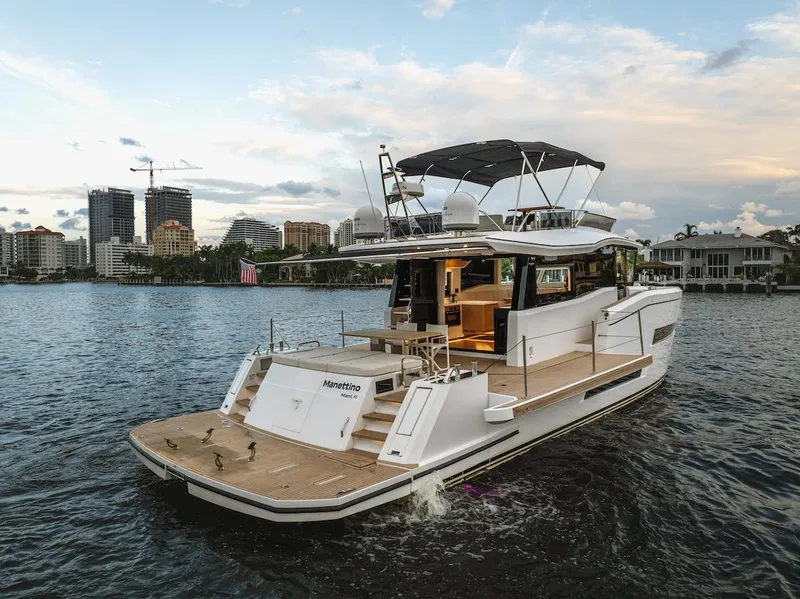 Slide: The Image of 2022 Pardo Yachts E60 cruising on a scenic waterfront with city skyline. - 13