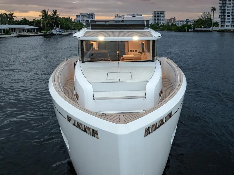 Slide: The Image of 2022 Pardo Yachts E60 luxury yacht on calm water at sunset. - 2