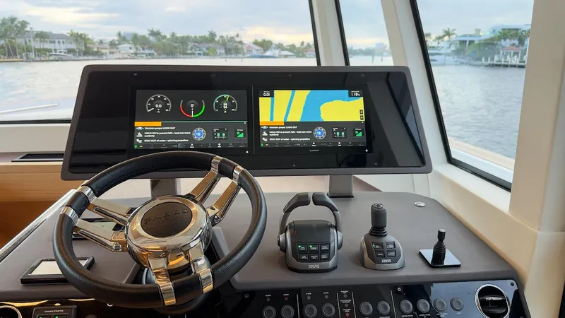 Slide: The Image of Pardo Yachts E60 2022 helm with dual navigation screens and steering wheel. - 33