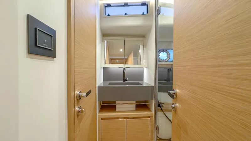 Slide: The Image of Modern bathroom interior on 2022 Pardo Yachts E60, featuring sleek sink and wooden cabinetry. - 35