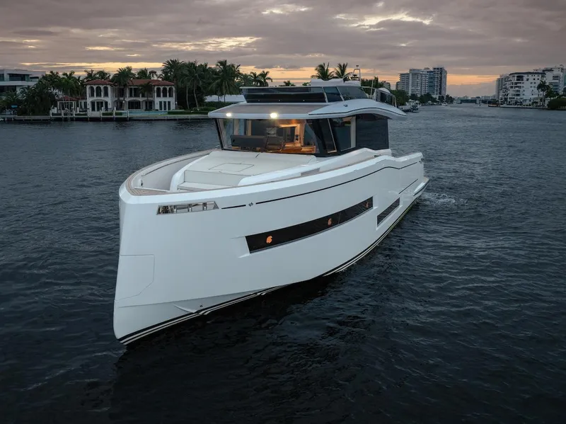 Slide: The Image of 2022 Pardo Yachts E60 cruising on a serene waterway at sunset. - 4