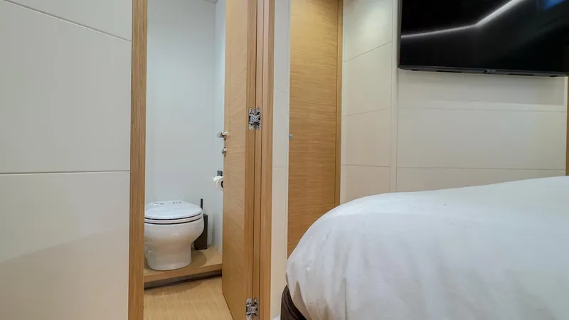 Slide: The Image of Interior of 2022 Pardo Yachts E60, featuring a modern bedroom and bathroom. - 42