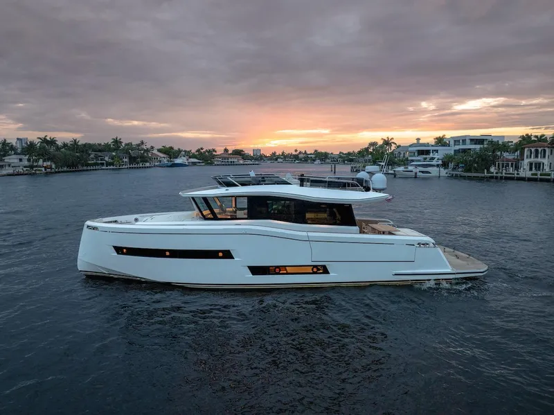 Slide: The Image of 2022 Pardo Yachts E60 cruising at sunset on a serene waterway. - 5