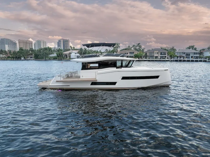 Slide: The Image of 2022 Pardo Yachts E60 cruising on a scenic waterfront at sunset. - 6