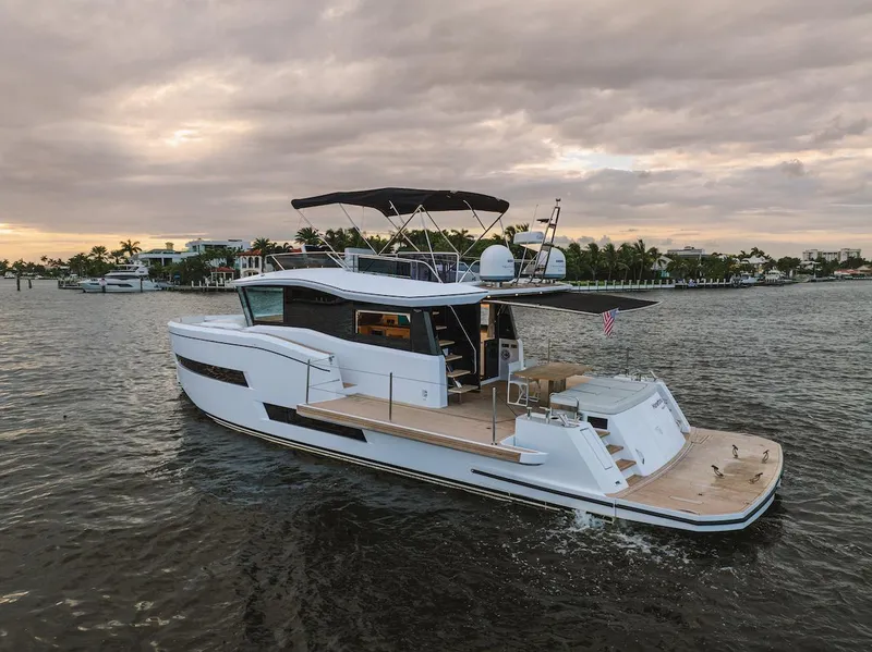 Slide: The Image of 2022 Pardo Yachts E60 cruising on a calm waterway at sunset. - 9