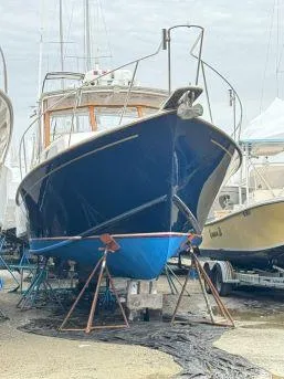 Slide: The Image of 1997 Fortier 33 HT Express boat on stands in a marina. - 14