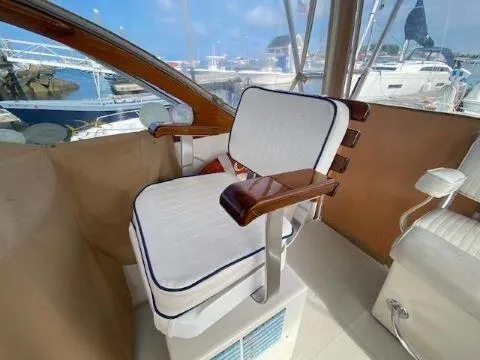 Slide: The Image of Captain's chair on 1997 Fortier 33 HT Express boat, docked at marina. - 17