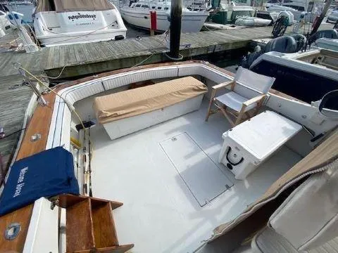 Slide: The Image of 1997 Fortier 33 HT Express boat interior with seating and storage at a marina. - 20