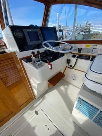 Slide: The Image of 1997 Fortier 33 HT Express helm with navigation equipment and wooden accents. - 28