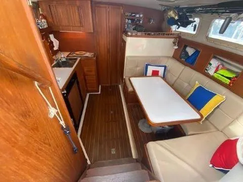 Slide: The Image of Interior of 1997 Fortier 33 HT Express boat with cozy seating and wooden finishes. - 31