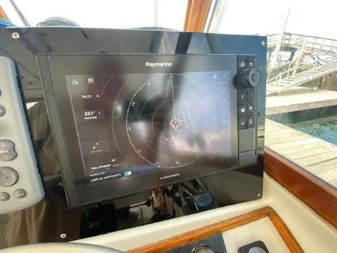 Slide: The Image of Raymarine navigation system on 1997 Fortier 33 HT Express boat dashboard. - 32