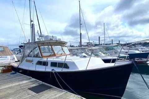 Slide: The Image of Fortier 33 HT Express 1997 docked at marina, cloudy sky background. - 6