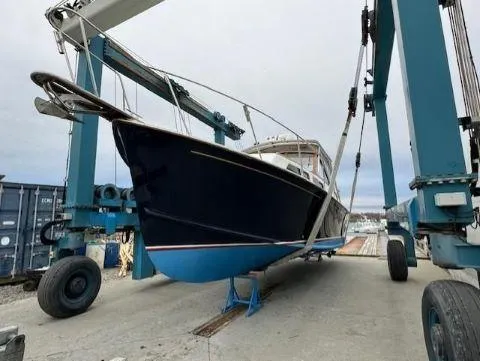 Slide: The Image of Fortier 33 HT Express 1997 boat on a lift at a marina. - 8