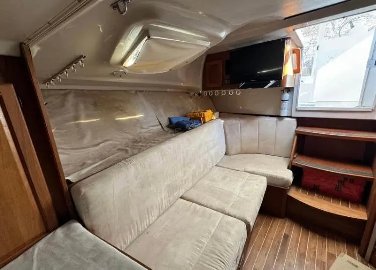 Slide: The Image of 1996 Luhrs Tournament 320 Open cabin interior with beige seating and wood accents. - 2