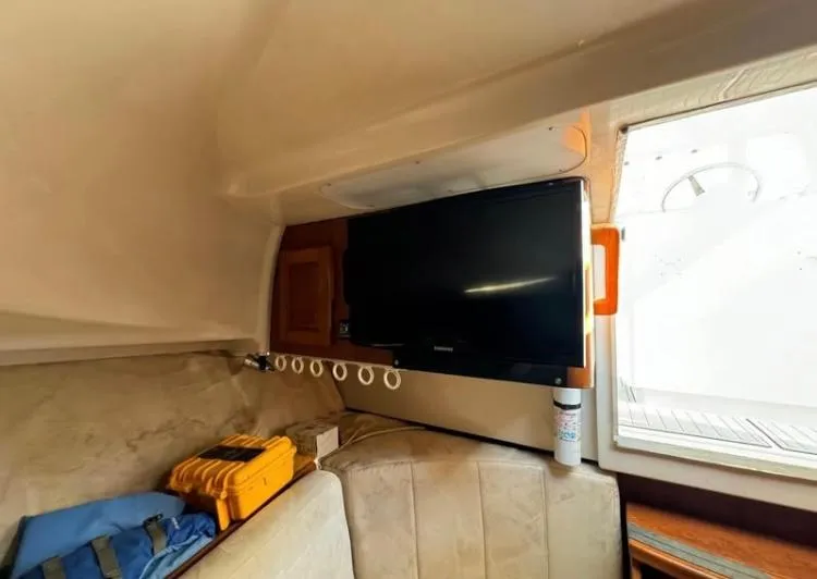 Slide: The Image of 1996 Luhrs Tournament 320 Open cabin interior with TV and seating area. - 3