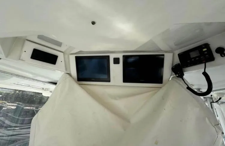 Slide: The Image of 1996 Luhrs Tournament 320 Open helm with dual screens and radio equipment. - 5