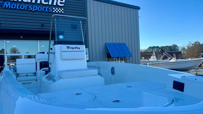 Slide: The Image of 2025 Bayliner T18 Limited Edition boat at dealership, showcasing sleek design and spacious deck. - 4