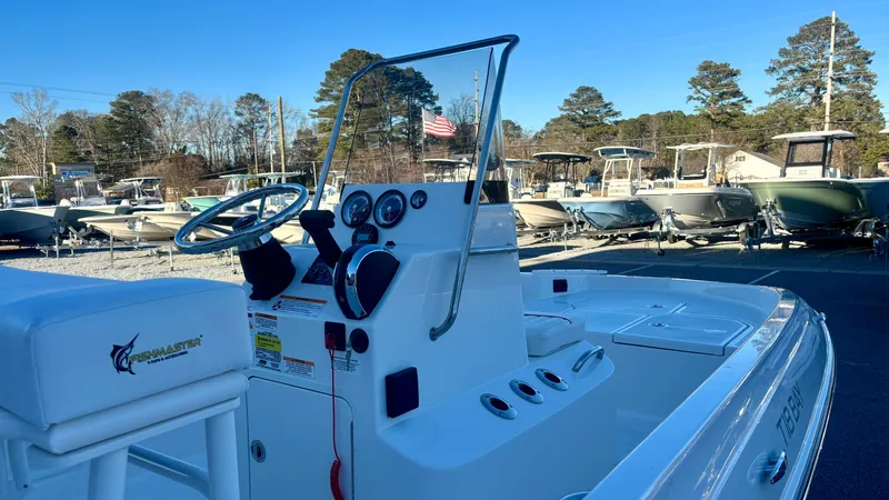 Slide: The Image of 2025 Bayliner T18 Limited Edition boat with sleek console and seating, displayed outdoors. - 7